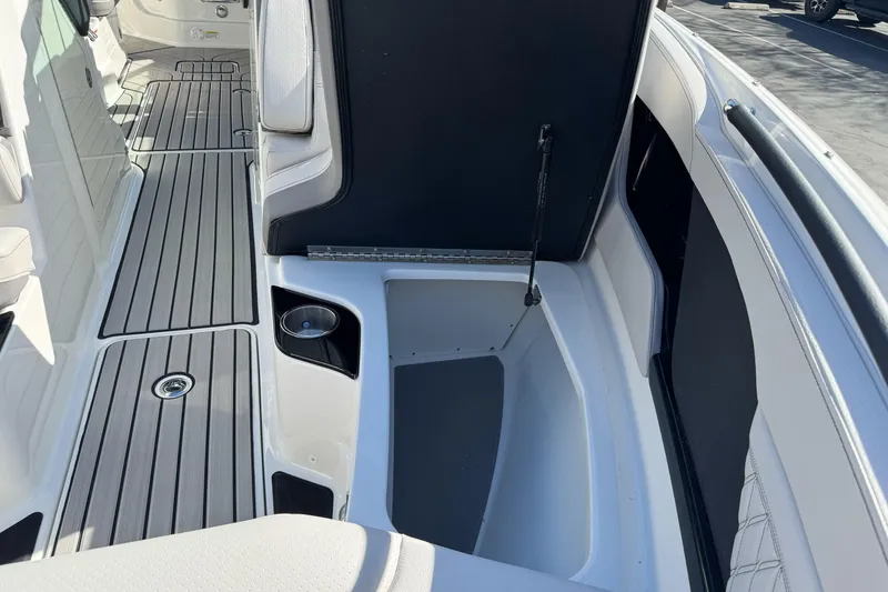 Slide: The Image of 2026 Sea Ray SLX 260 boat interior with open storage compartment and sleek flooring. - 44