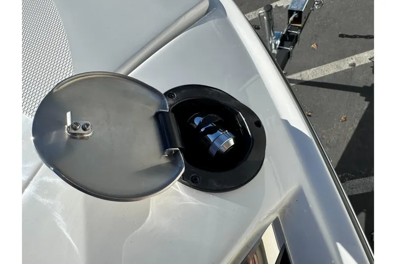 Slide: The Image of Fuel cap on 2026 Sea Ray SLX 260 boat, open with metal cover. - 51