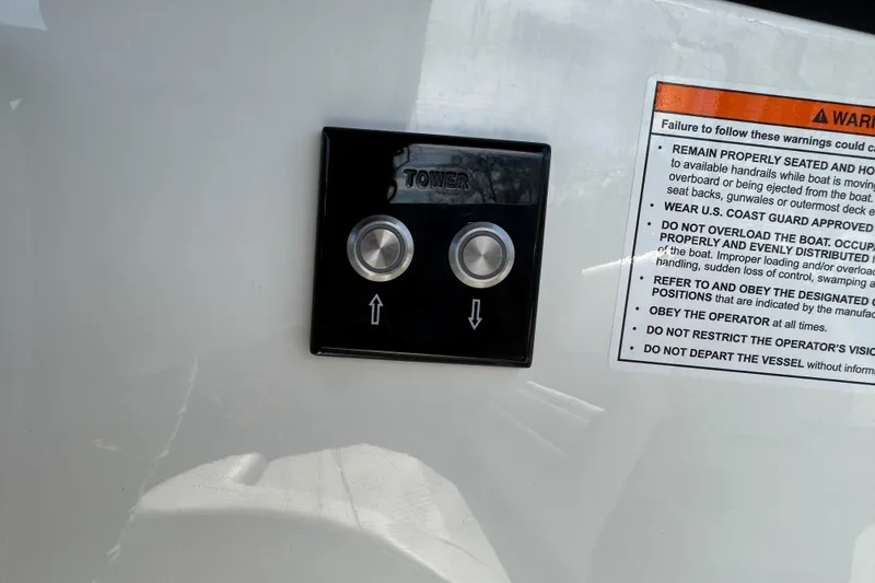 Slide: The Image of Control panel and safety warning on 2026 Sea Ray SLX 260 boat. - 52