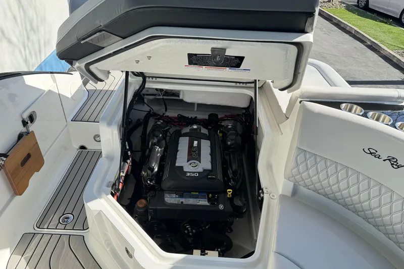Slide: The Image of 2026 Sea Ray SLX 260 boat engine compartment with open hatch, showcasing the 350 engine. - 53