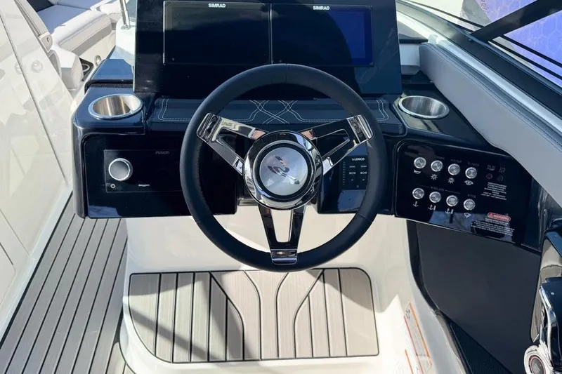 Slide: The Image of 2026 Sea Ray SLX 260 helm with modern steering wheel and control panel. - 30