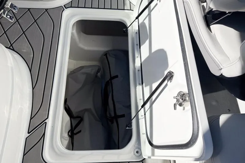 Slide: The Image of Storage compartment on 2026 Sea Ray SLX 260 boat, featuring sleek design and ample space. - 25