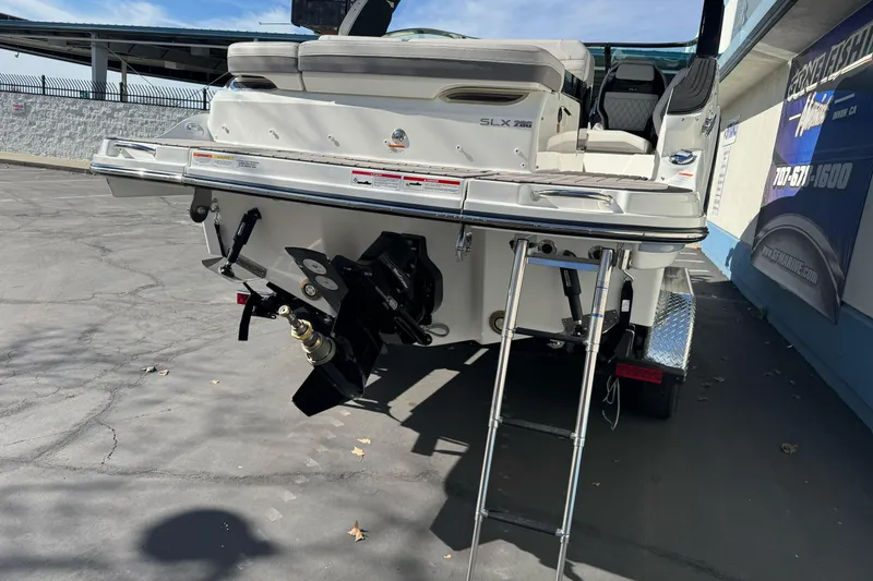 Slide: The Image of 2026 Sea Ray SLX 260 boat rear view with ladder and outboard motor. - 9