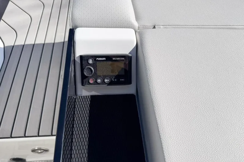 Slide: The Image of 2026 Sea Ray SLX 260 boat interior with Fusion MS-NRX300 audio control panel. - 15