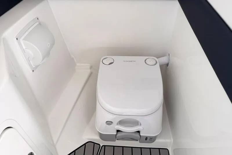 Slide: The Image of 2026 Sea Ray SLX 260 boat interior with compact marine toilet. - 28