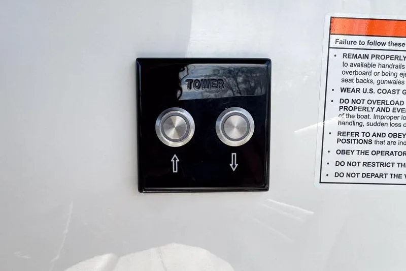 Slide: The Image of Control panel with up and down buttons on 2026 Sea Ray SLX 260 boat. - 45