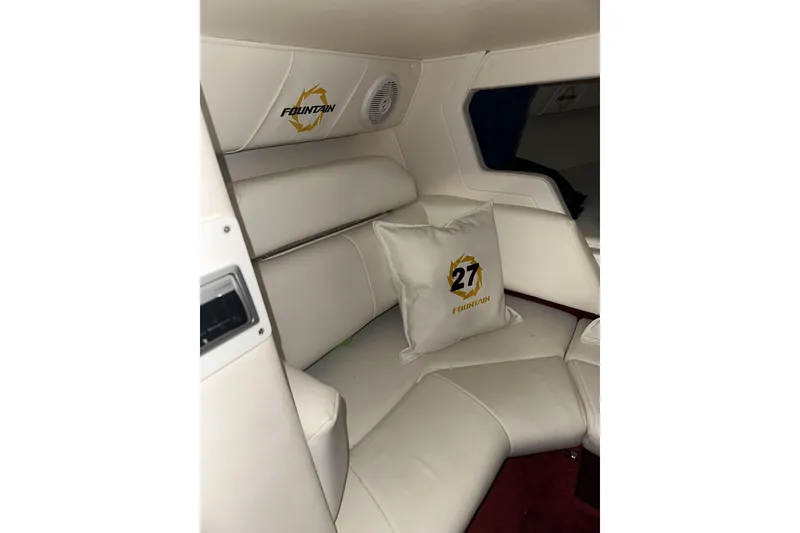 Slide: The Image of Interior of 2005 Fountain 27 Fever boat with white seating and branded cushion. - 11