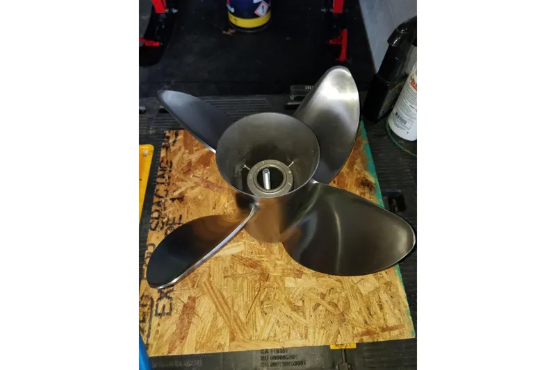 Slide: The Image of Stainless steel boat propeller for 2005 Fountain 27 Fever on wooden surface. - 12