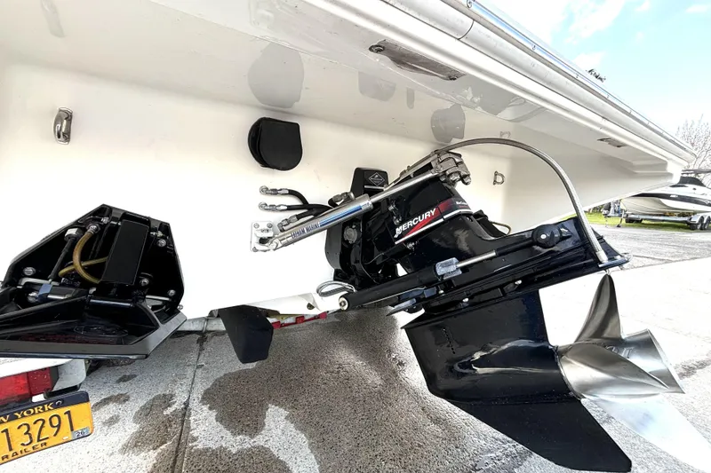 Slide: The Image of 2005 Fountain 27 Fever boat with Mercury outboard motor and propeller, parked on concrete. - 17