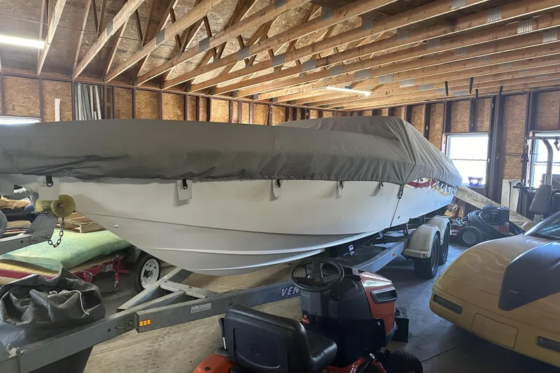 Slide: The Image of 2005 Fountain 27 Fever boat covered in a garage, on a trailer. - 4