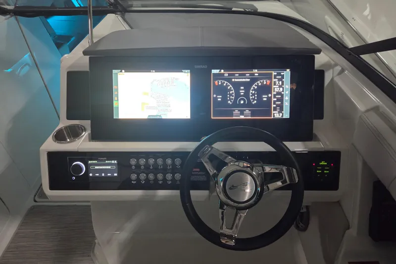 Slide: The Image of 2023 Sea Ray SLX 350 helm with modern controls and dual display screens. - 10