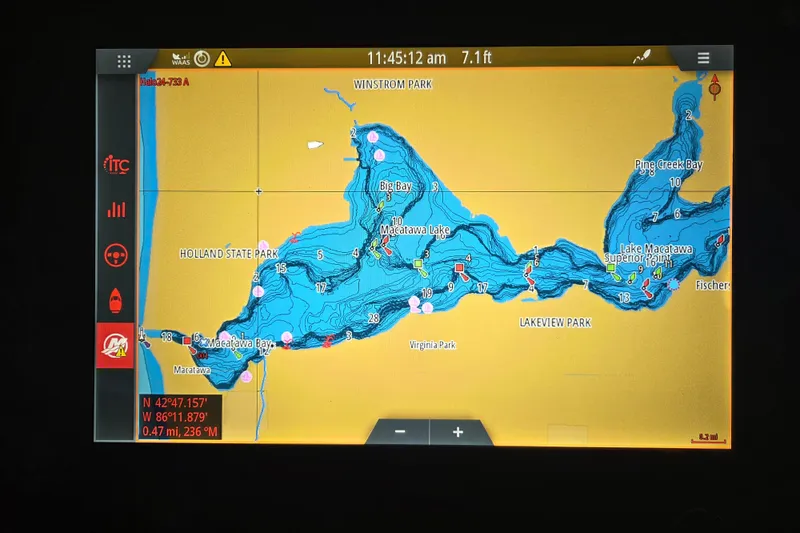 Slide: The Image of Simrad marine radio on 2023 Sea Ray SLX 350 boat, next to quilted seat. - 14