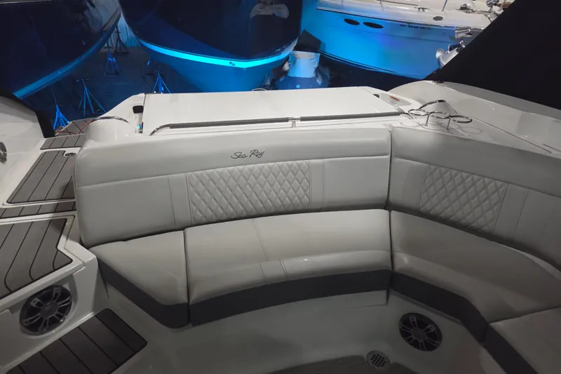 Slide: The Image of 2023 Sea Ray SLX 350 interior with seating and built-in cooler. - 23