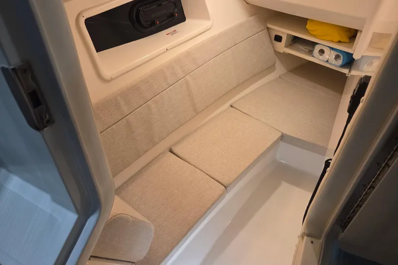 Slide: The Image of 2023 Sea Ray SLX 350 boat bathroom with toilet, sink, and storage cabinet. - 45