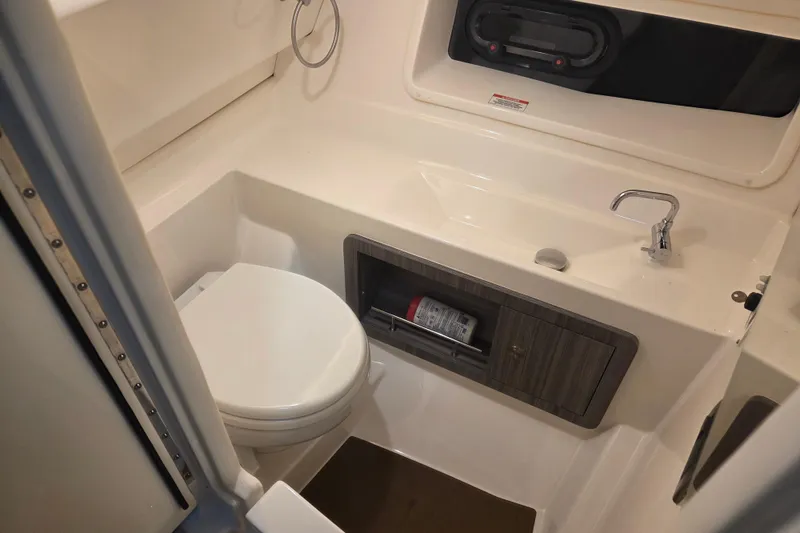 Slide: The Image of 2023 Sea Ray SLX 350 interior with ambient blue lighting and sleek design. - 47