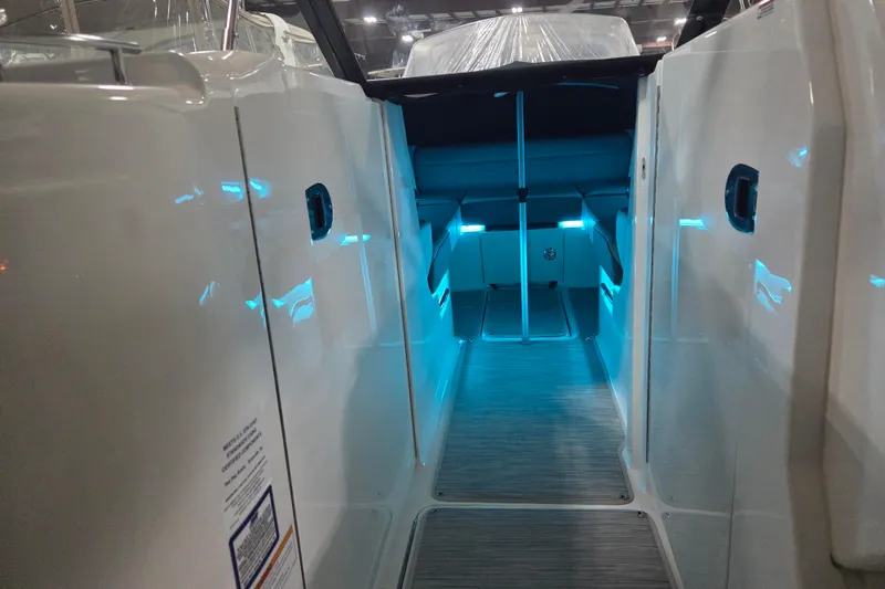 Slide: The Image of 2023 Sea Ray SLX 350 boat interior with illuminated ceiling and panoramic windows. - 49