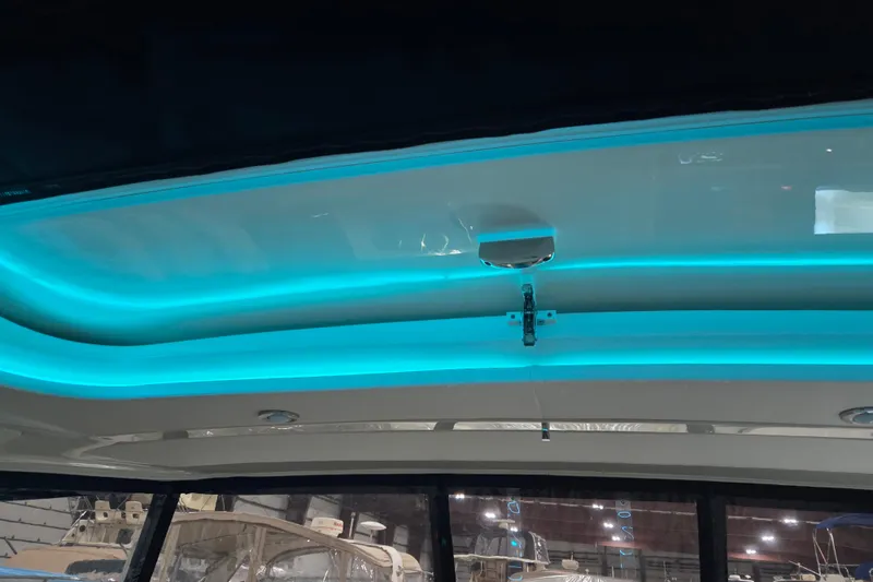 Slide: The Image of 2023 Sea Ray SLX 350 boat interior under warehouse roof. - 52