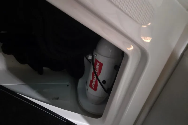 Slide: The Image of 2023 Sea Ray SLX 350 interior detail with speaker and storage compartment. - 62