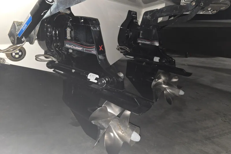 Slide: The Image of 2023 Sea Ray SLX 350 boat propellers illuminated in blue underwater lighting. - 7