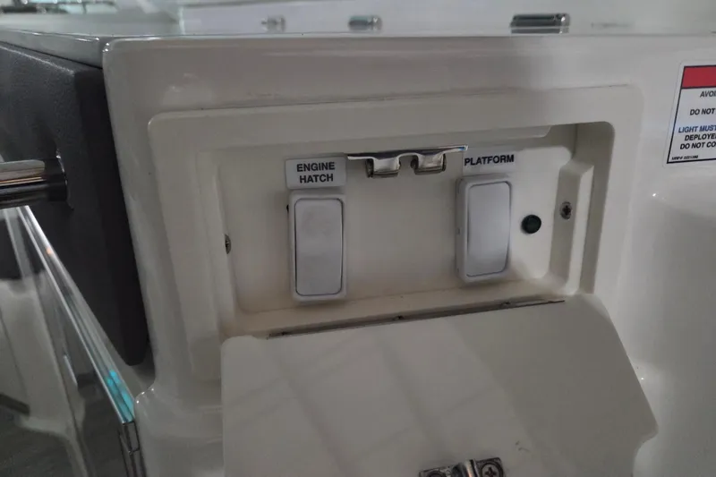 Slide: The Image of 2023 Sea Ray SLX 350 boat storage compartment with wooden and metal components. - 71