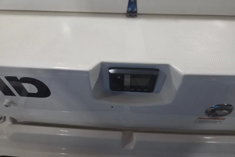 Slide: The Image of 2023 Sea Ray SLX 350 boat storage compartment with wooden and metal components. - 73