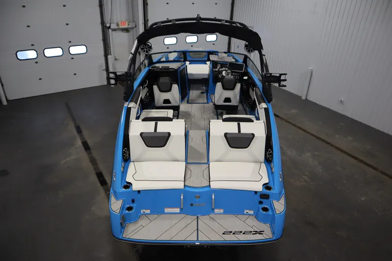 Slide: The Image of 2023 Yamaha Boats 222XD interior, featuring sleek blue and white seating in a spacious layout. - 10