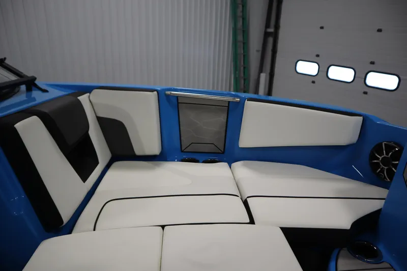 Slide: The Image of 2023 Yamaha Boats 222XD interior with white and black seating, blue accents, and speaker. - 14