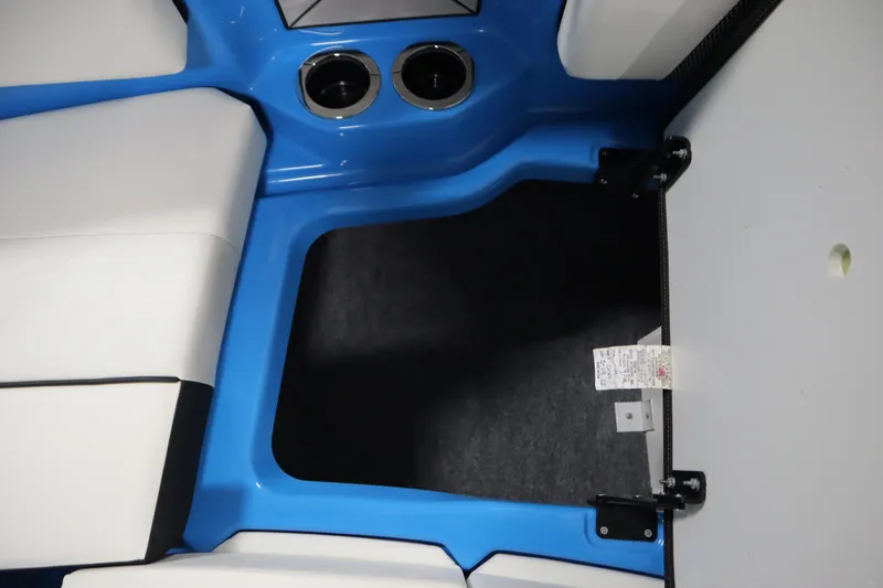 Slide: The Image of Interior view of 2023 Yamaha Boats 222XD, featuring blue and white seating with cup holders. - 16