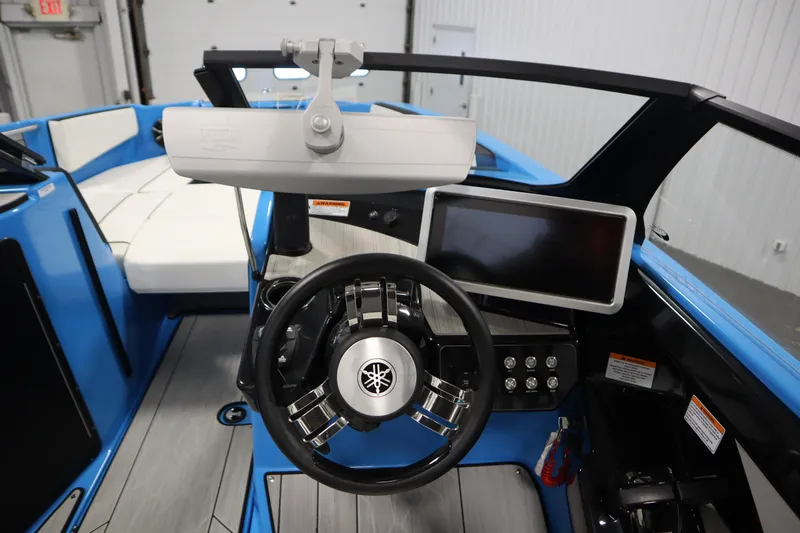 Slide: The Image of 2023 Yamaha Boats 222XD cockpit with steering wheel, touchscreen, and blue interior. - 18