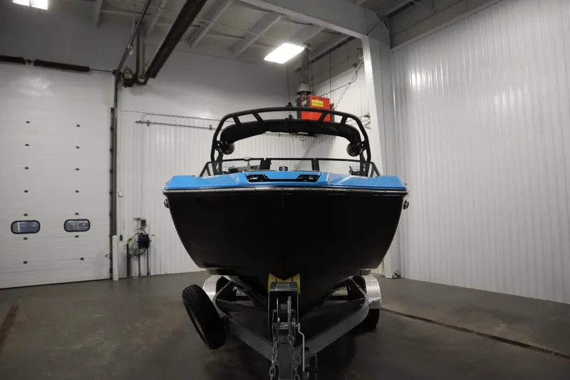 Slide: The Image of 2023 Yamaha Boats 222XD in a garage, front view on trailer. - 2
