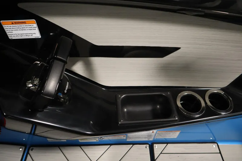 Slide: The Image of 2023 Yamaha Boats 222XD interior with control panel and cup holders. - 25