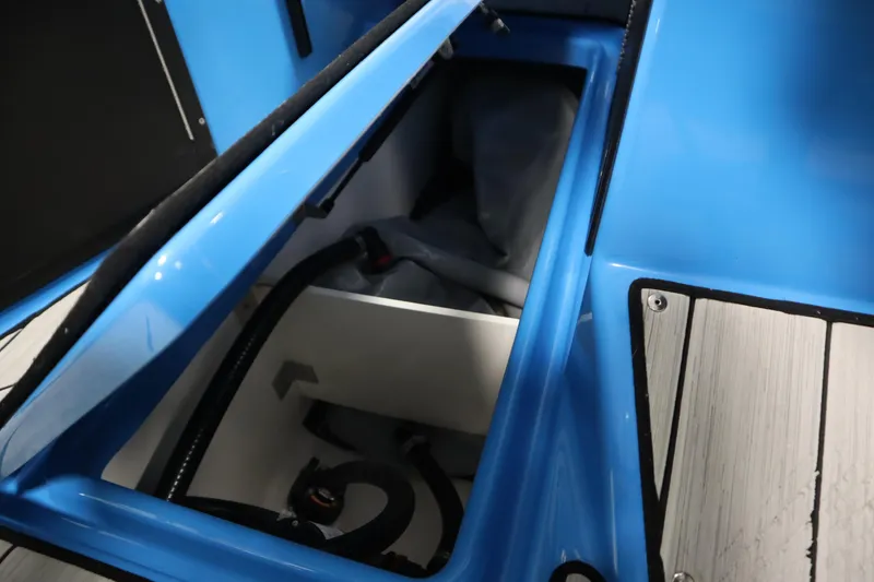 Slide: The Image of 2023 Yamaha Boats 222XD storage compartment with blue interior and equipment. - 32