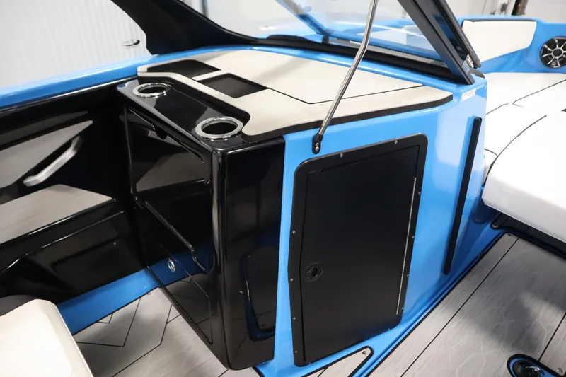 Slide: The Image of 2023 Yamaha Boats 222XD interior with sleek black and blue design, featuring cup holders. - 33