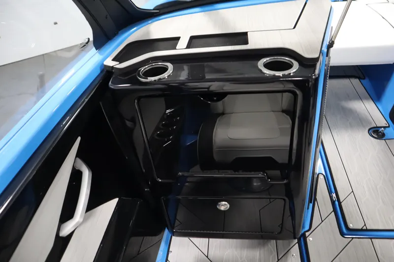 Slide: The Image of 2023 Yamaha Boats 222XD interior with seating and cup holders, featuring sleek black and blue design. - 34