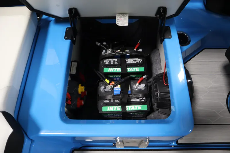 Slide: The Image of 2023 Yamaha Boats 222XD battery compartment with Interstate batteries, blue interior. - 39