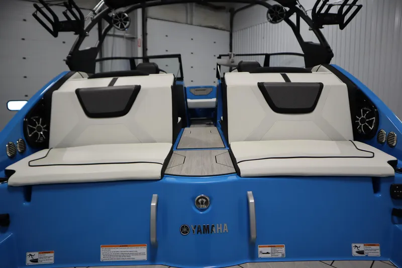 Slide: The Image of 2023 Yamaha Boats 222XD, blue exterior, white seating, modern design, rear view. - 46
