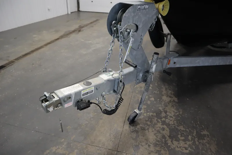 Slide: The Image of Trailer hitch of 2023 Yamaha Boats 222XD, featuring chains and wheel support. - 51