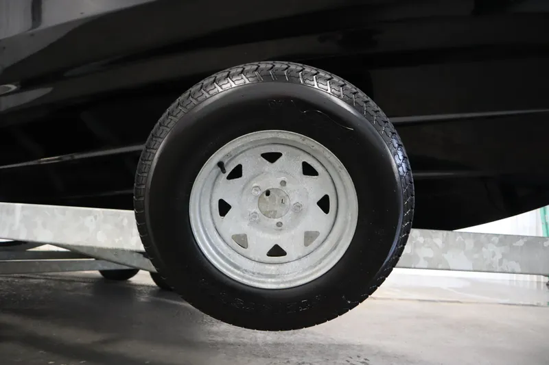 Slide: The Image of Trailer wheel of 2023 Yamaha Boats 222XD, close-up view. - 52