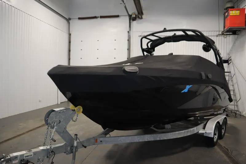 Slide: The Image of 2023 Yamaha Boats 222XD covered on trailer in indoor storage facility. - 55