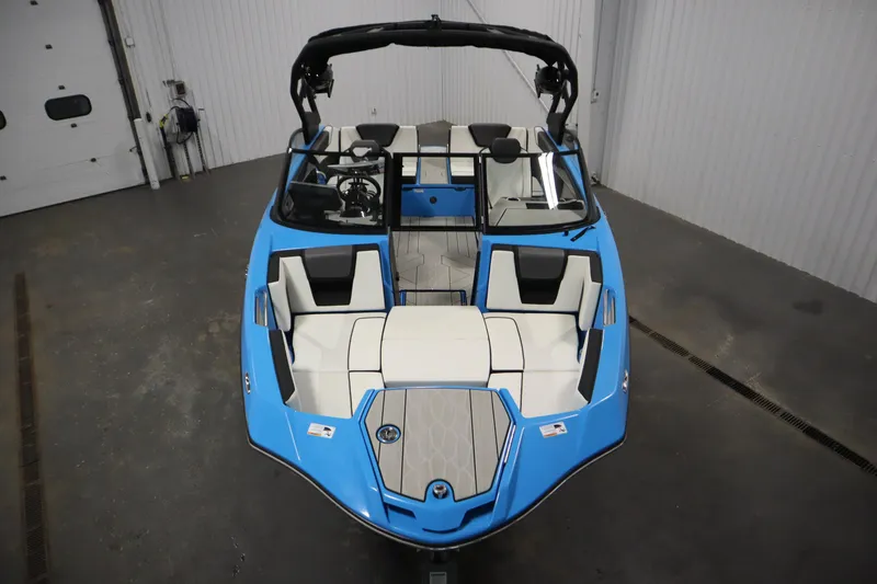 Slide: The Image of 2023 Yamaha Boats 222XD, blue and white interior, in a showroom setting. - 9
