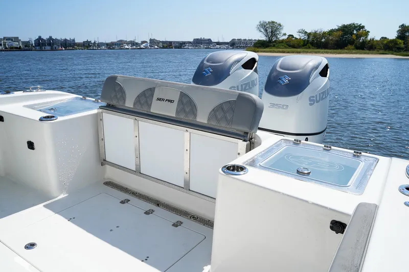 Slide: The Image of 2021 Sea Pro 320 DLX Offshore boat with dual Suzuki 350 engines on a calm lake. - 5