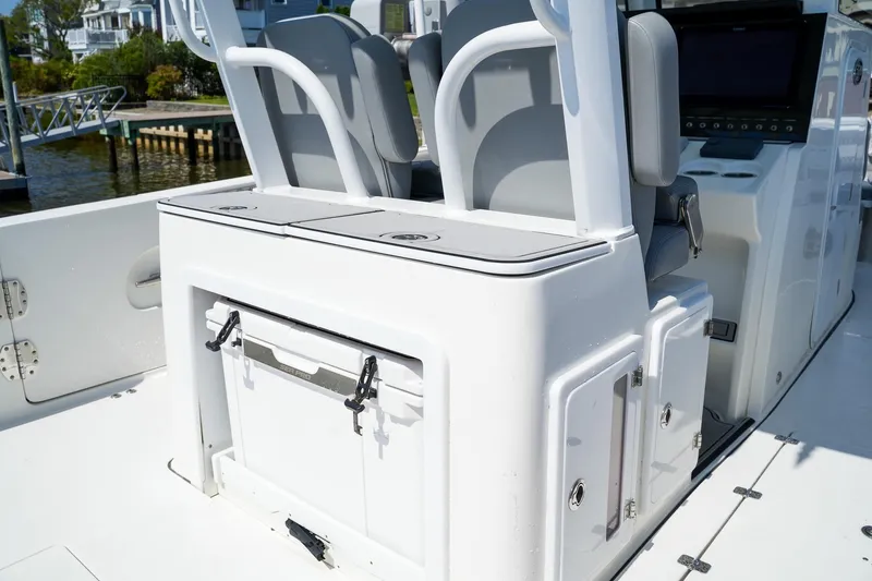Slide: The Image of 2021 Sea Pro 320 DLX Offshore boat interior with seating and storage compartments. - 6