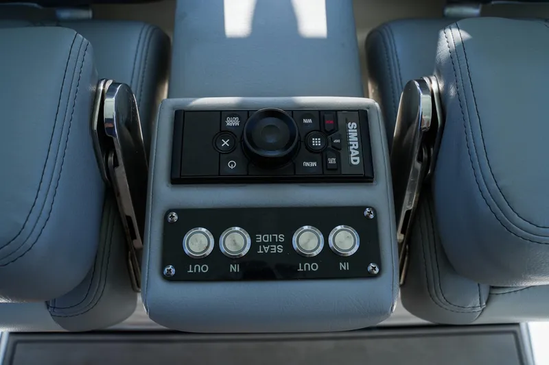 Slide: The Image of Control panel of 2021 Sea Pro 320 DLX Offshore boat with Simrad system and seat adjustment buttons. - 8