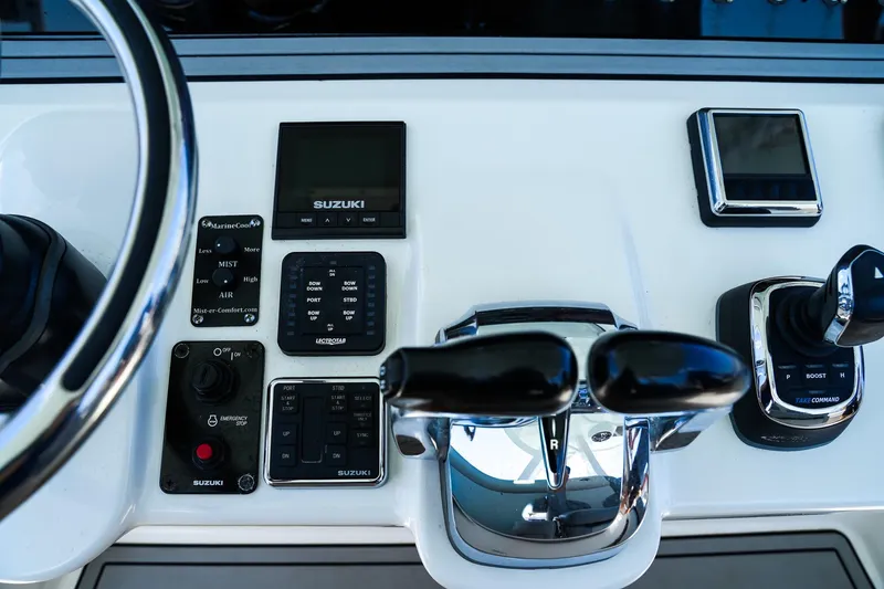 Slide: The Image of 2021 Sea Pro 320 DLX Offshore boat controls with Suzuki display and joystick. - 9