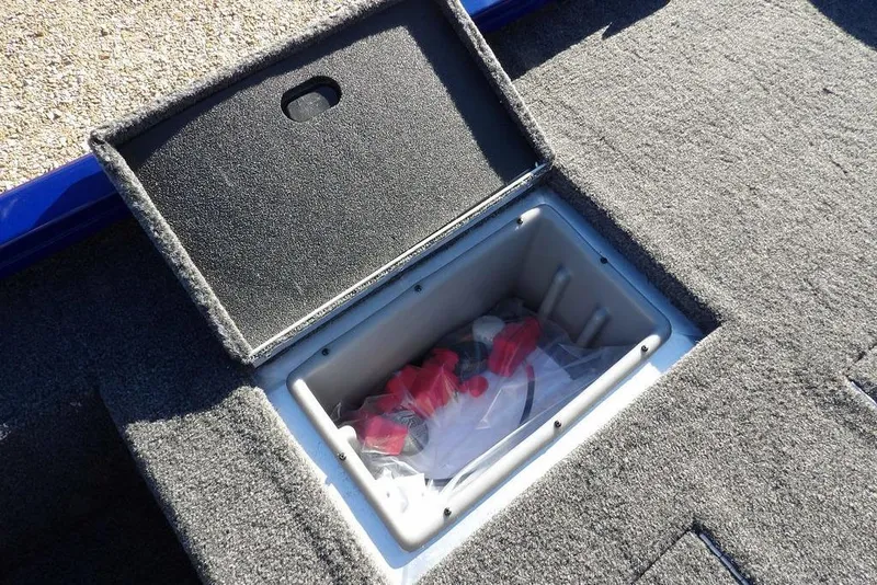 Slide: The Image of Open storage compartment in 2026 Crestliner XF 189 boat, showing interior contents. - 13