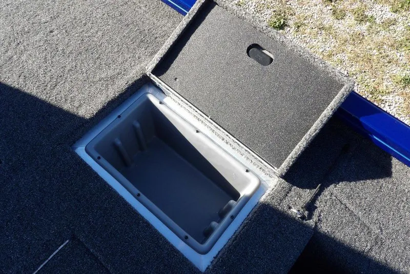 Slide: The Image of Open storage compartment on 2026 Crestliner XF 189 boat, featuring carpeted interior. - 15