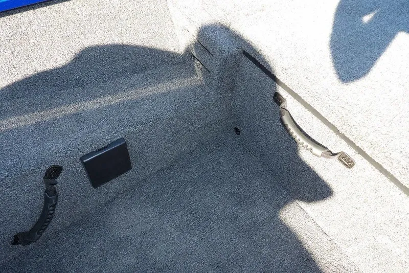 Slide: The Image of 2026 Crestliner XF 189 boat interior with carpeted storage area and handles. - 22