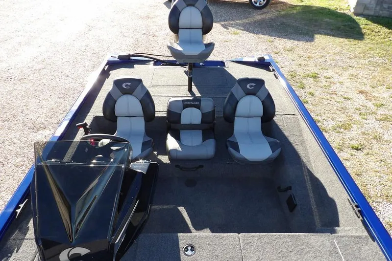 Slide: The Image of 2026 Crestliner XF 189 boat interior with three gray and black seats. - 27