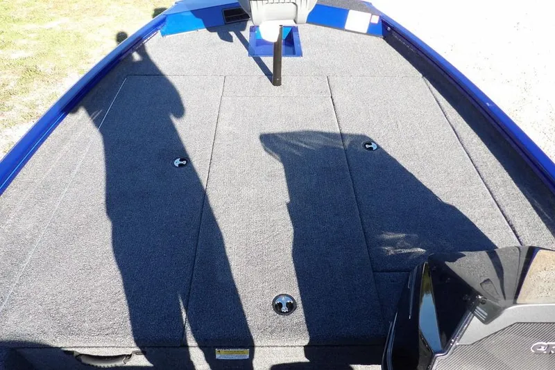 Slide: The Image of 2026 Crestliner XF 189 boat deck with carpeted surface and storage compartments. - 28