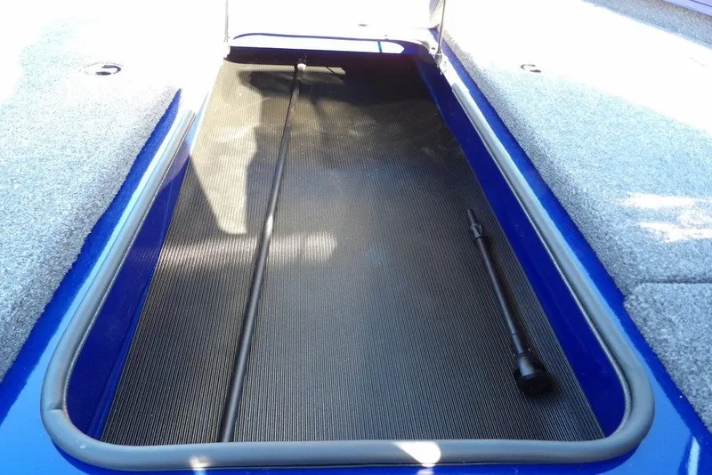 Slide: The Image of 2026 Crestliner XF 189 boat storage compartment with carpeted interior and rod holder. - 31